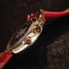 Zakiram Watch Side and Crown Detail Royal Muse Zakiram watch side view with gradient red cabochon crown details